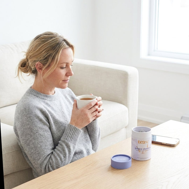 A woman with a cup of tea in the evening