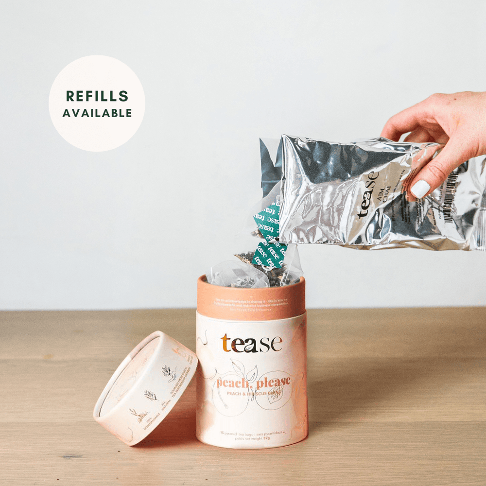 Tease Wellness Peach, Please tea blend in peach-colored tube with refill pouch pouring loose tea.