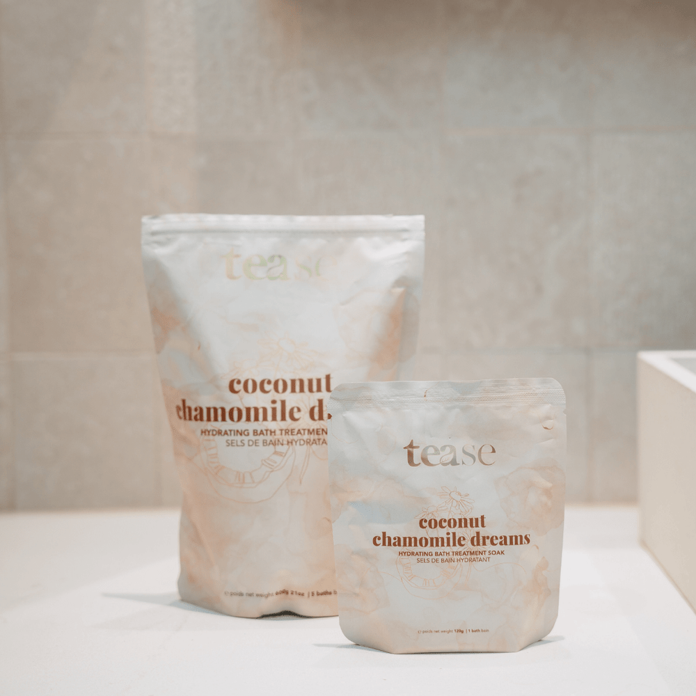 Tease Wellness Coconut Chamomile Dreams bath soak in 120g and 600g soft white resealable pouches with gold text.