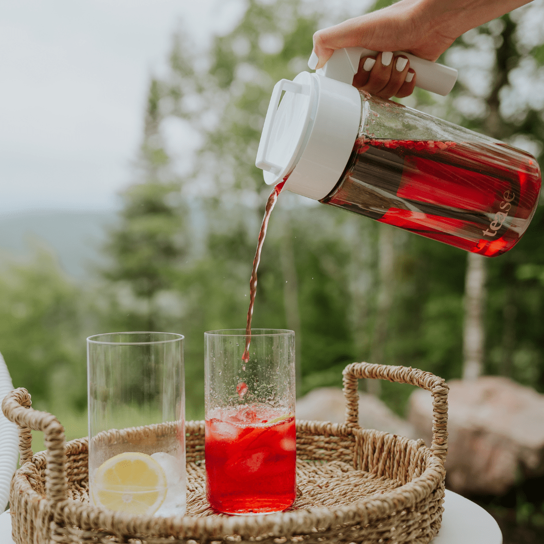 Tease Tea Cold Brew Iced Tea & Coffee Maker Kit pouring iced tea outdoors