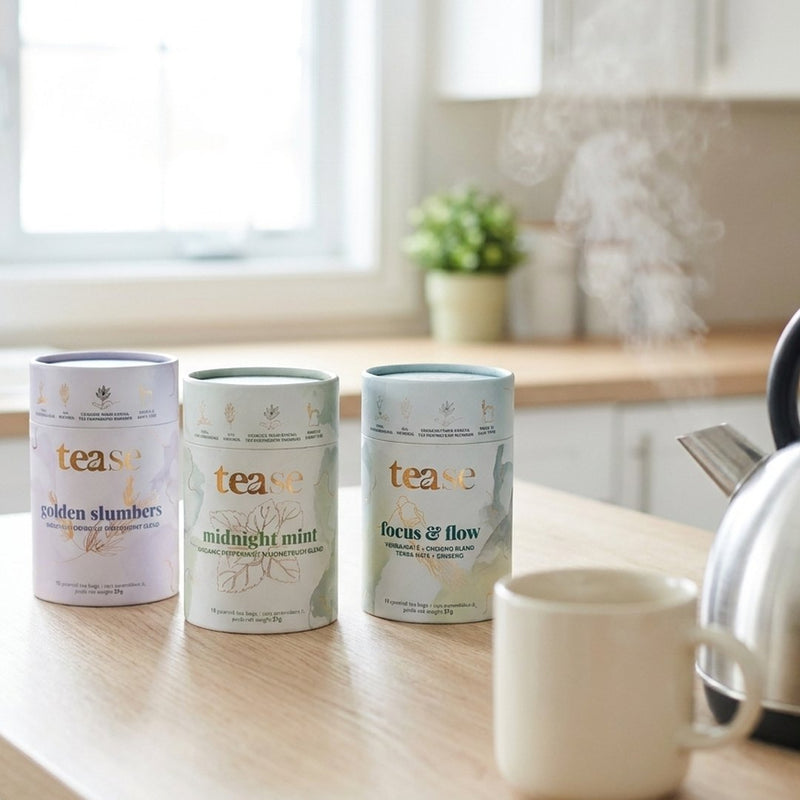 The three tins on a kitchen counter beside a mug and kettle