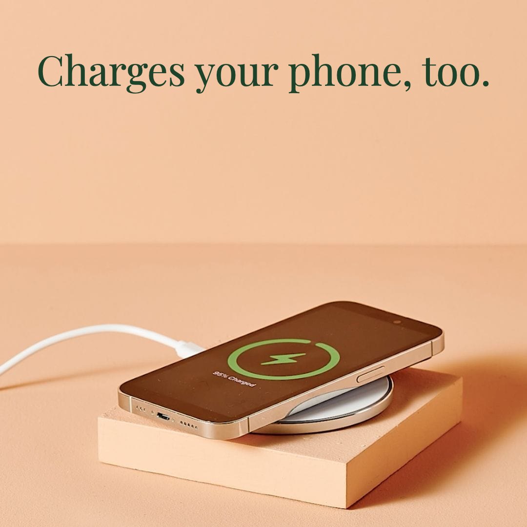 The coaster charging a phone wirelessly